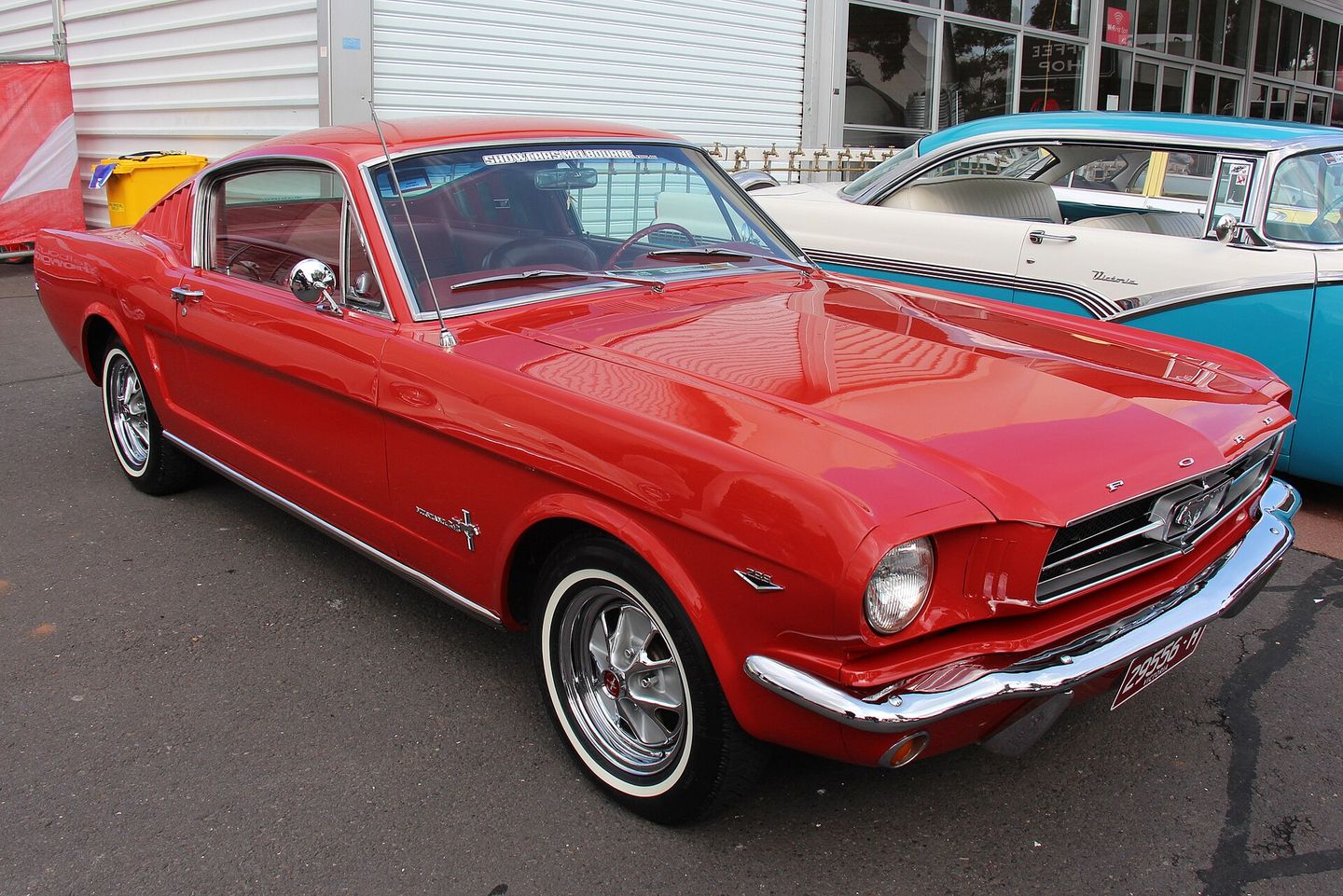 a 1965 ford mustang fastback, showing the classic long hood and short rear deck design