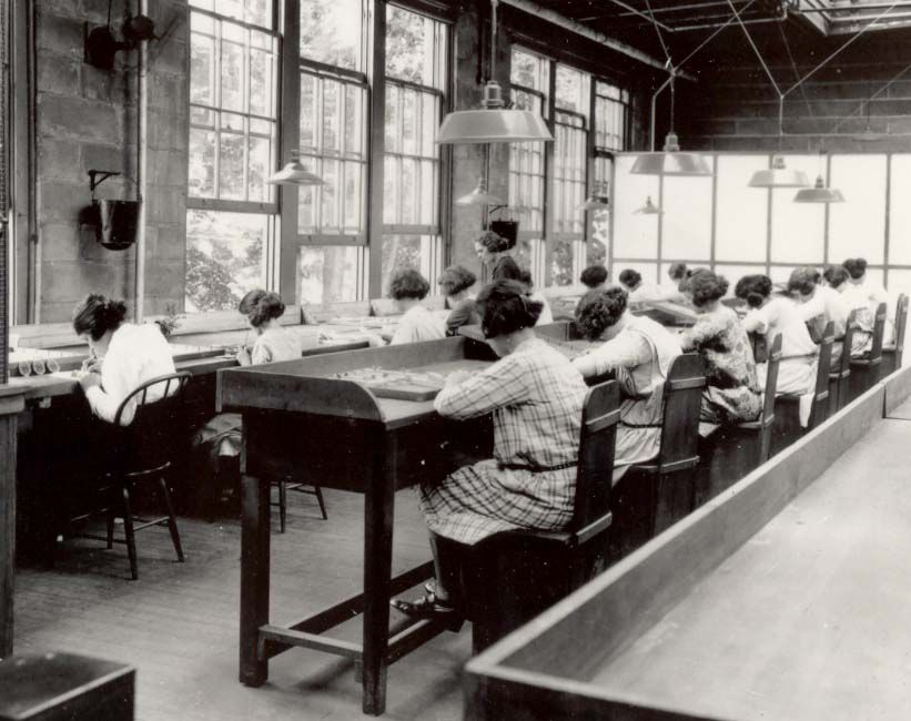 women painting watch dials with luminous radium paint in a factory, around 1922