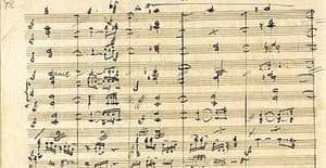 a page from beethoven's handwritten autograph manuscript of the ninth symphony, dense with corrections and crossed-out notation