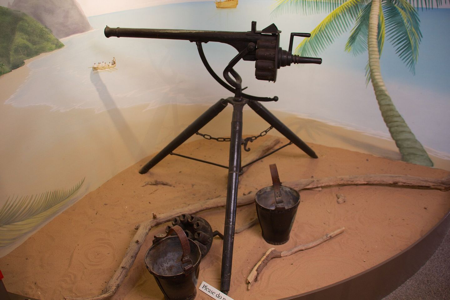a surviving puckle defence gun on display, showing the tripod mount, single barrel, and revolving cylinder