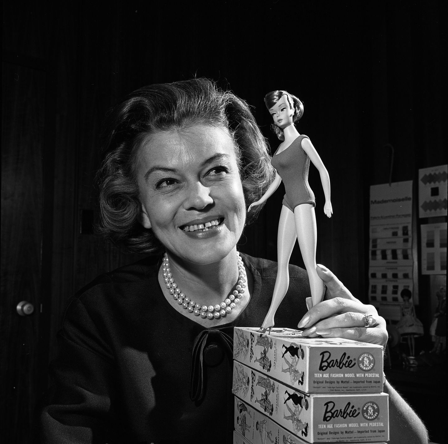 charlotte johnson, barbie's fashion designer, holding a 1965 barbie doll