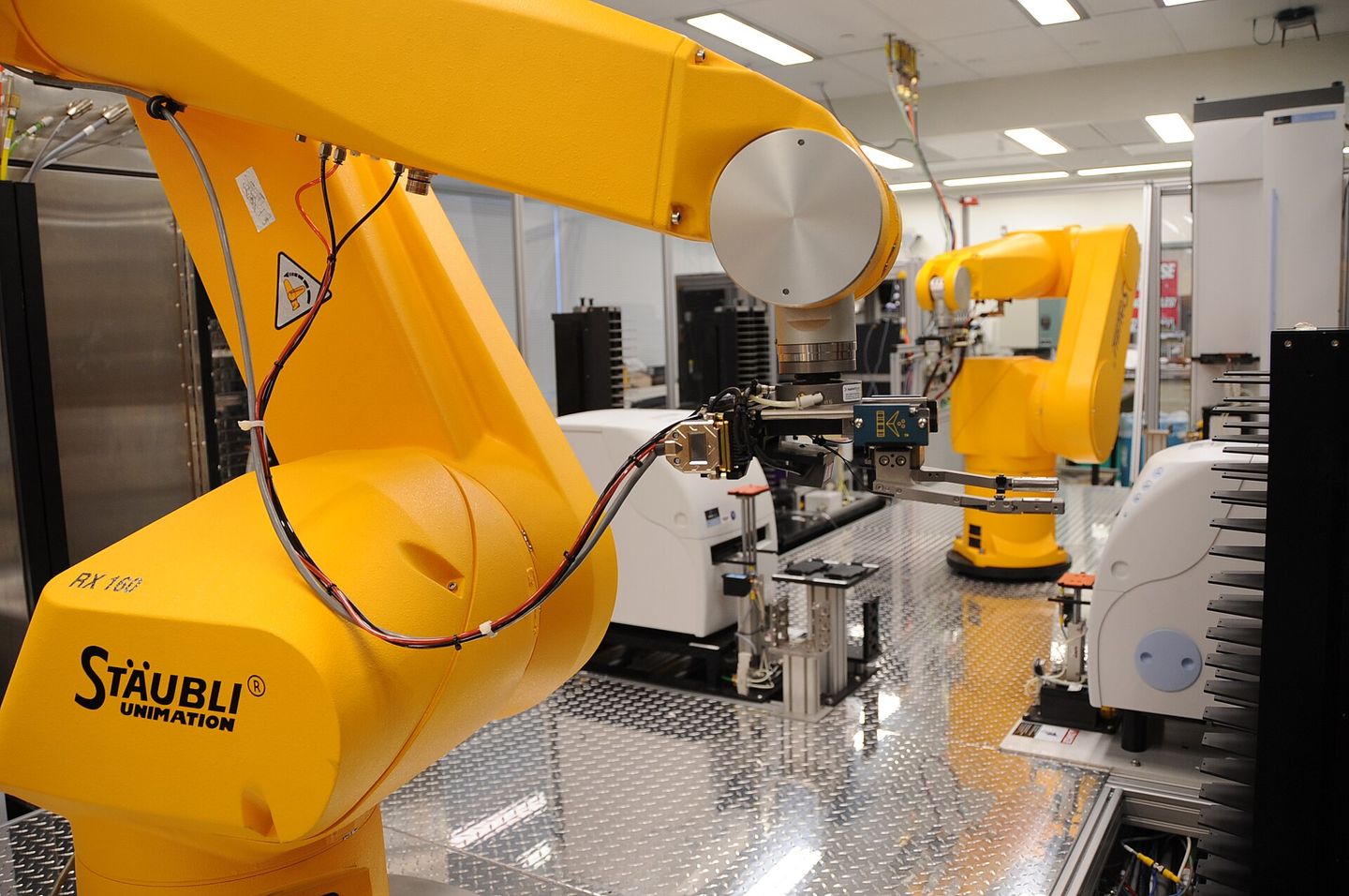 a laboratory robot performing automated chemical genomics tasks, a descendant of asimov's imagined mechanical servants