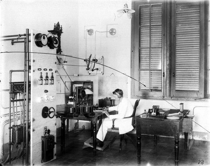 A telegraph operator receiving telegrams at Sabang, Dutch East Indies