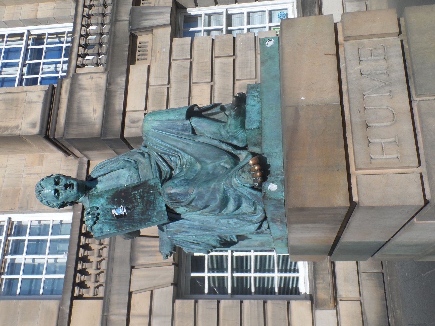 bronze statue of david hume seated, on the royal mile in edinburgh
