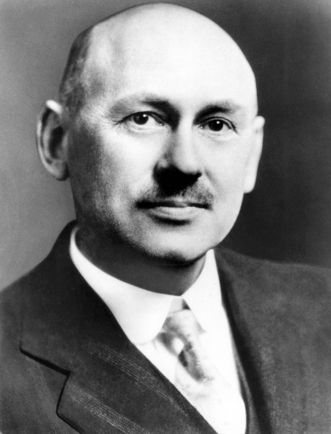 robert goddard standing next to his first liquid-fueled rocket in 1926