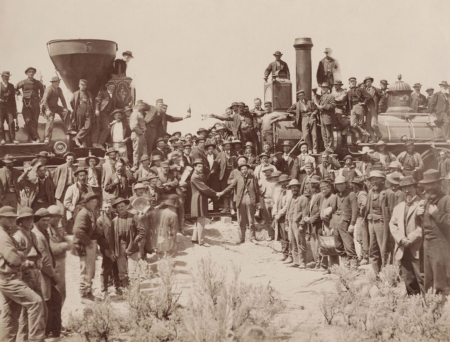 the famous photograph of east and west crews shaking hands at the completion of the transcontinental railroad at promontory summit, utah, may 10, 1869