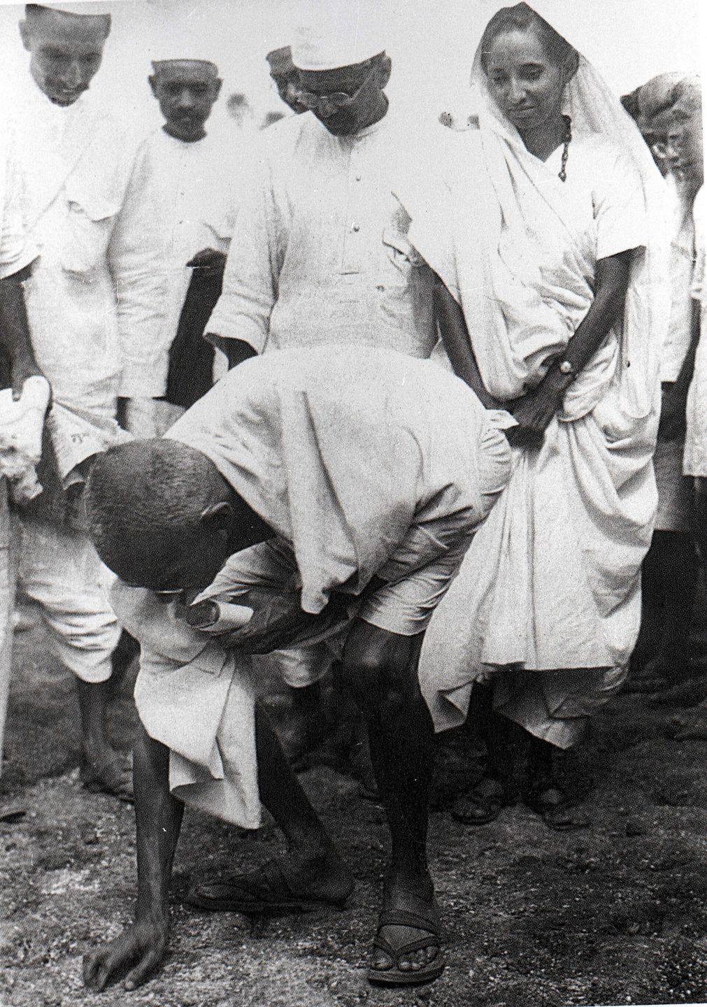 Gandhi picking up salt at Dandi on 5 April 1930