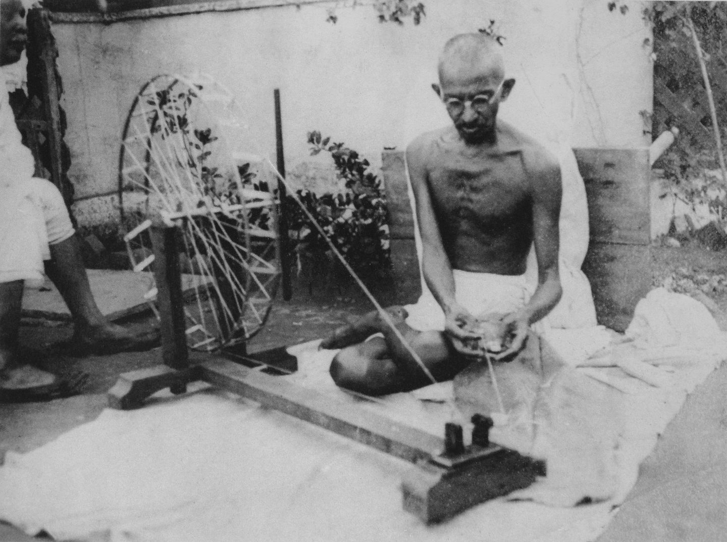 Gandhi at a spinning wheel