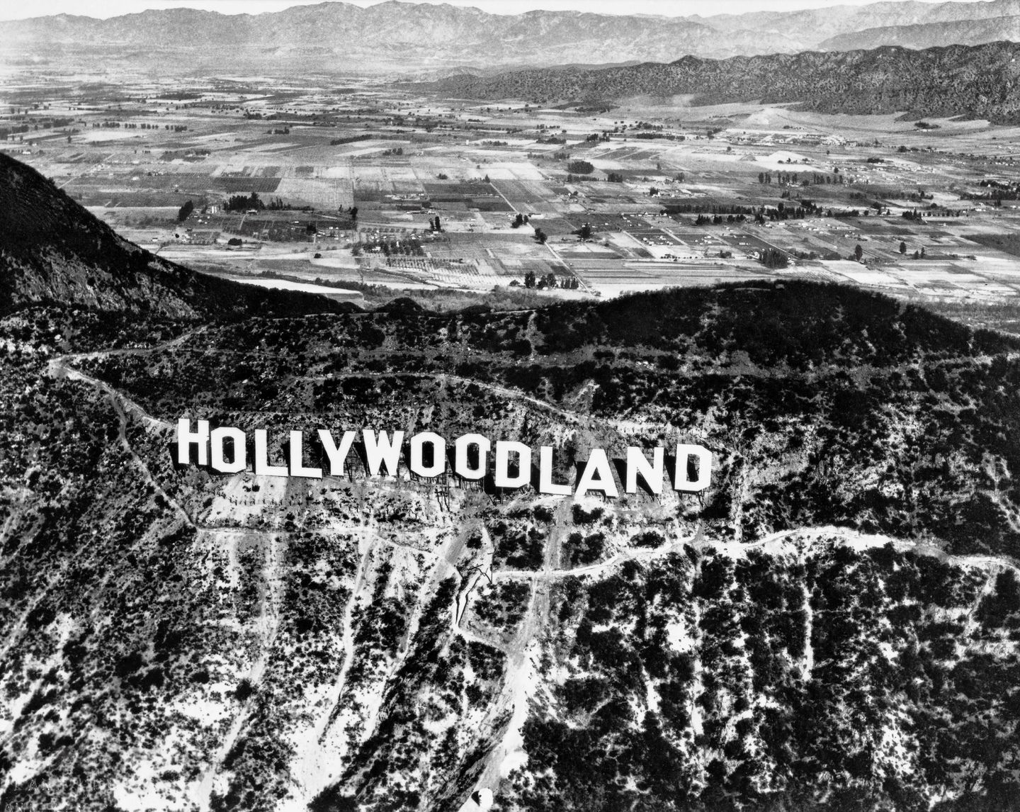 the original hollywoodland sign on the hillside in the 1920s
