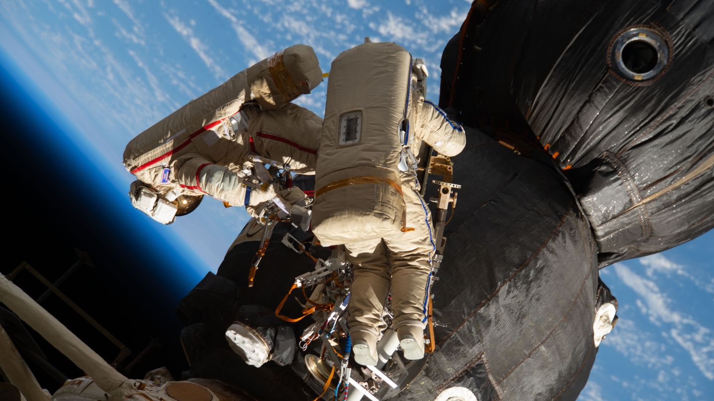 cosmonaut on spacewalk outside the international space station