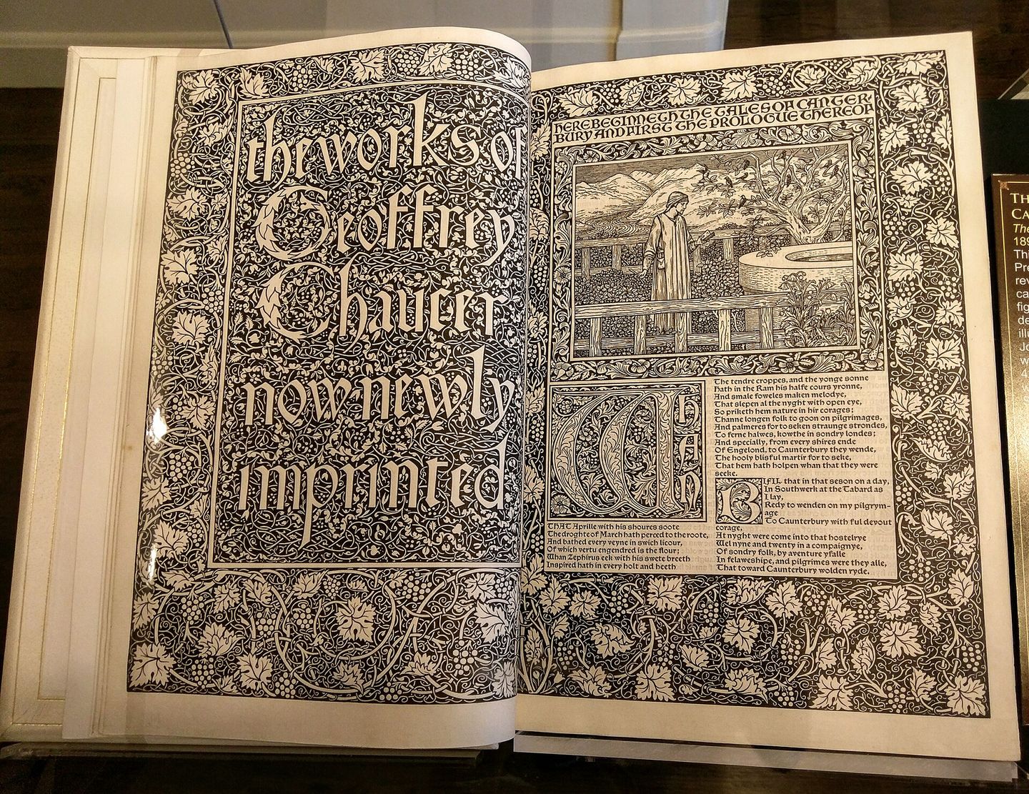 a printed page from the kelmscott chaucer with gothic type, dense floral borders, and a burne-jones woodcut illustration