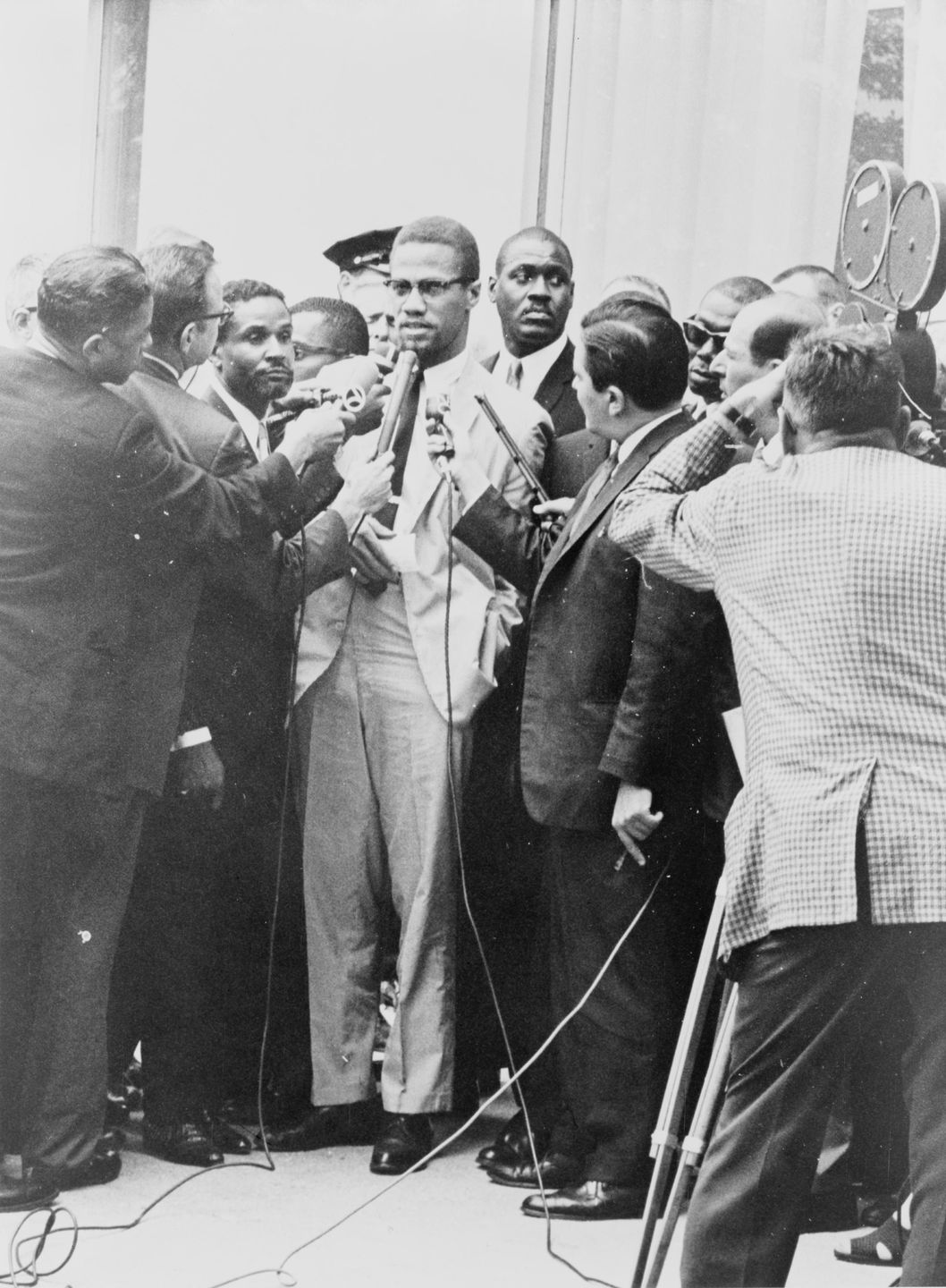 malcolm x speaking at a podium, 1964