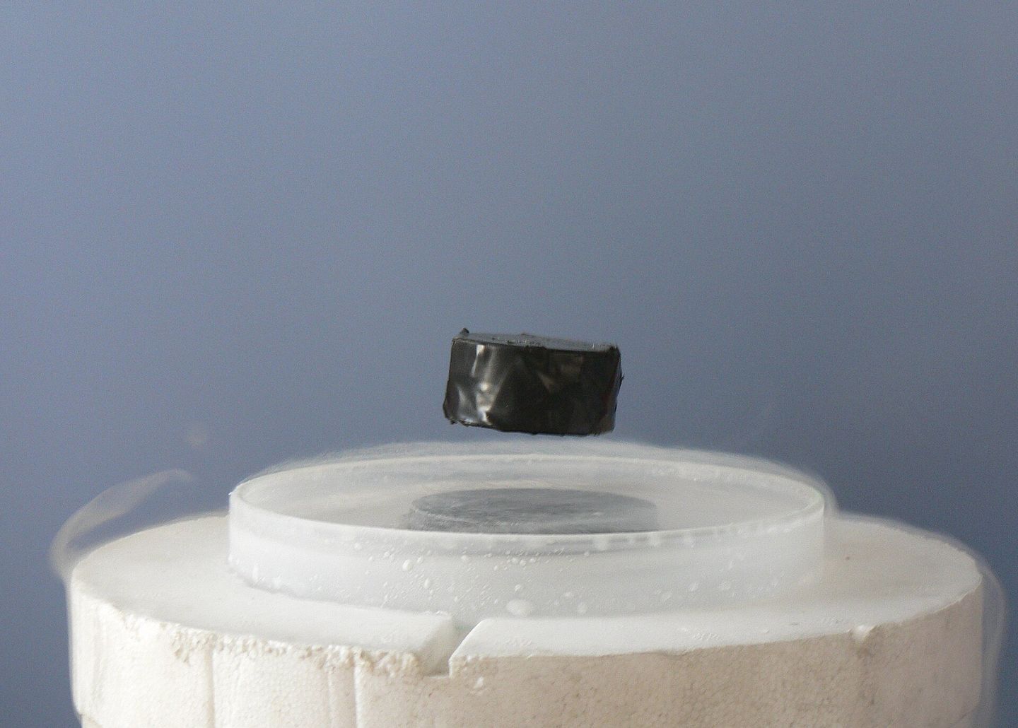 a magnet levitating above a superconductor cooled below its critical temperature