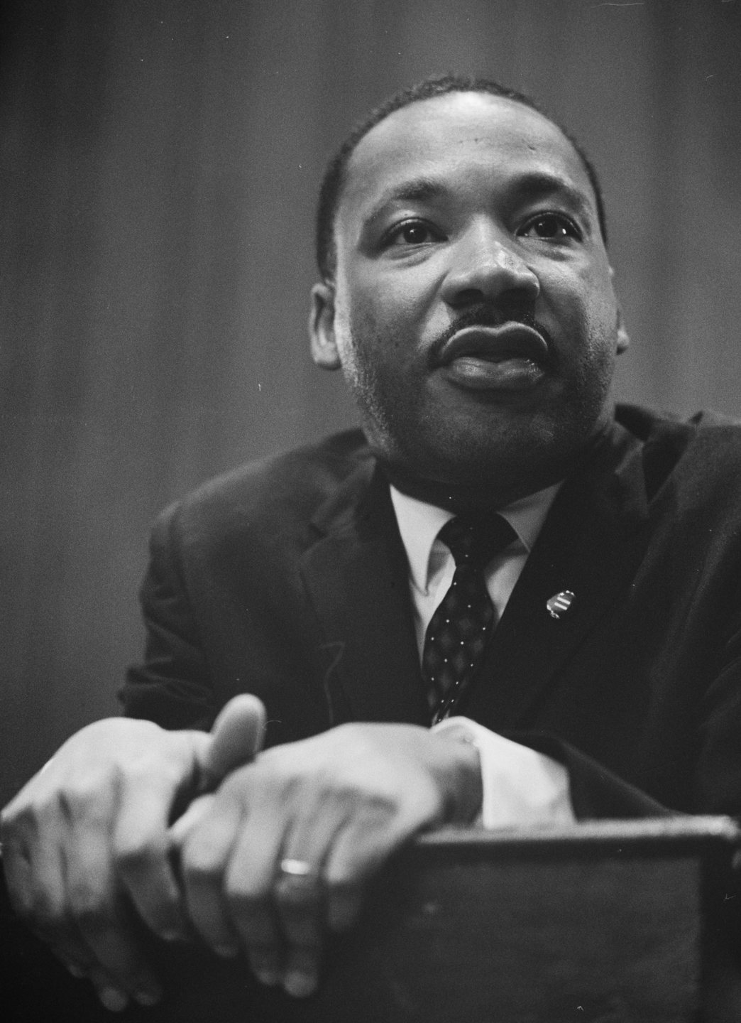 Martin Luther King Jr. leaning on a lectern, 1964
