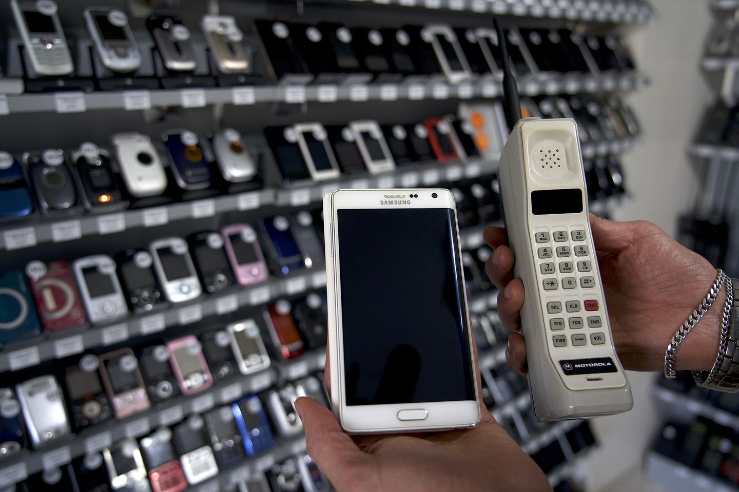A Motorola DynaTAC brick phone next to a modern Samsung Galaxy smartphone