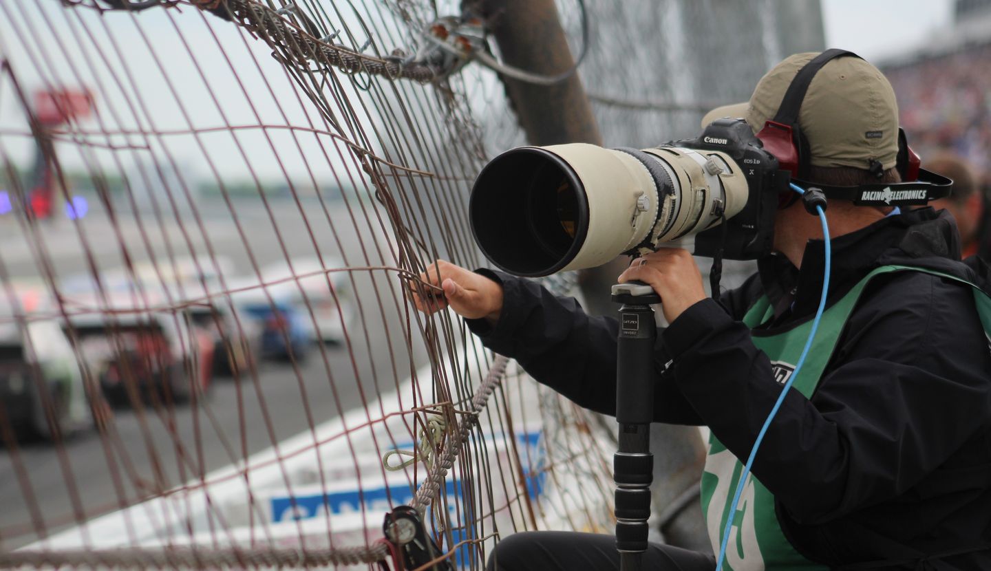 A sports photographer at work at a sporting event