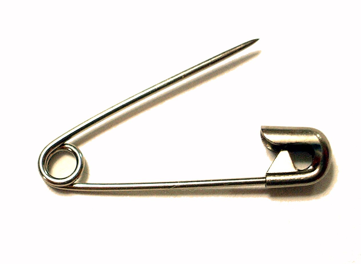 a modern safety pin, showing the coiled spring and clasp design invented by walter hunt in 1849