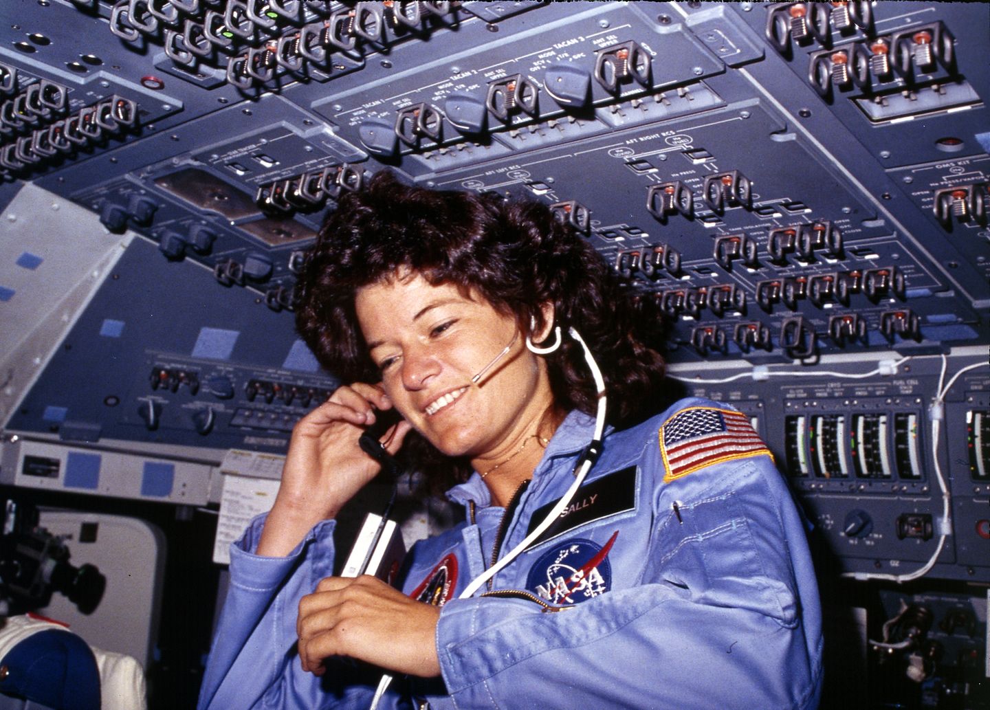 Sally Ride communicating with ground controllers from the shuttle flight deck