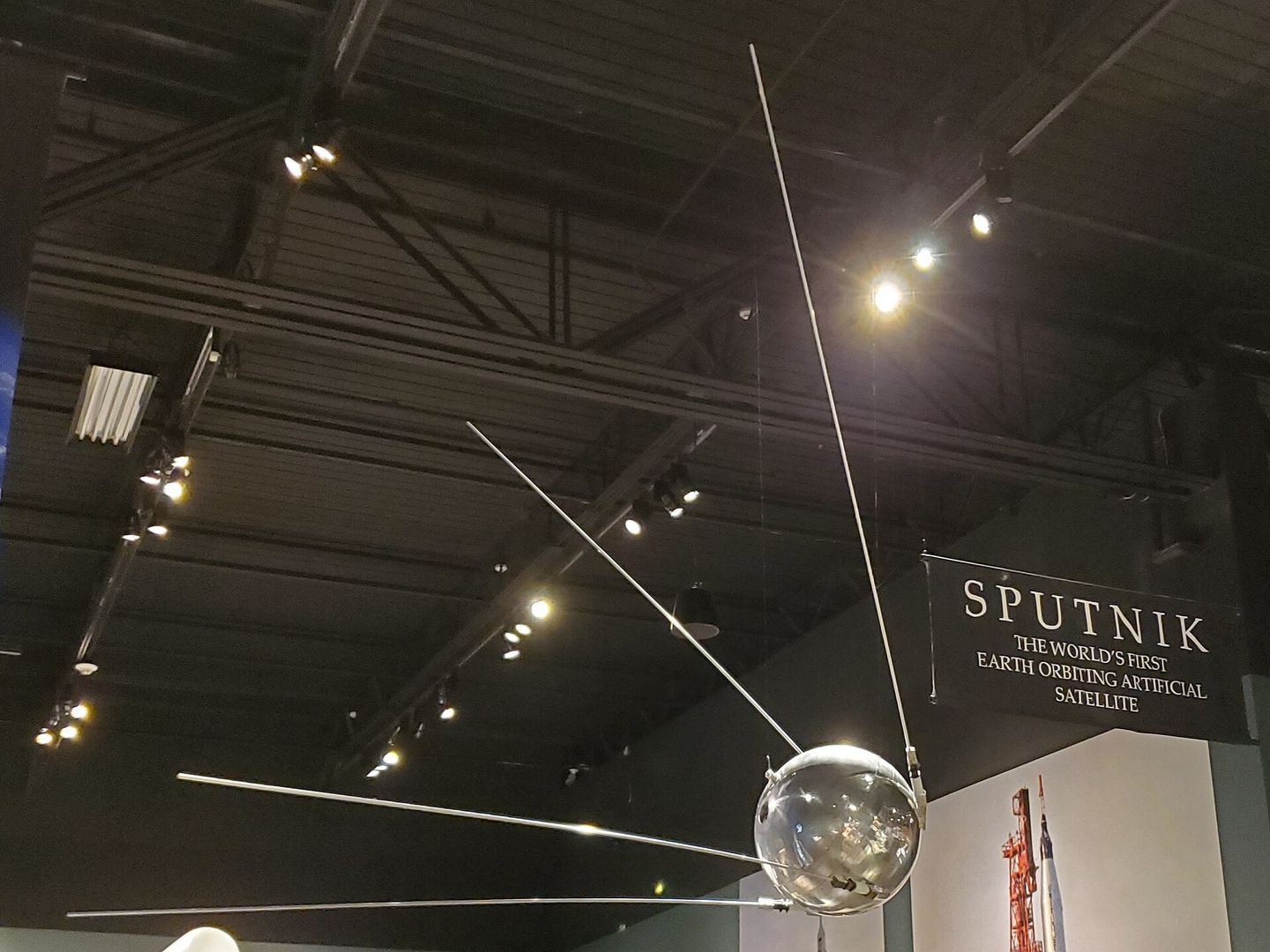 a sputnik 1 satellite model on display at the tellus science museum