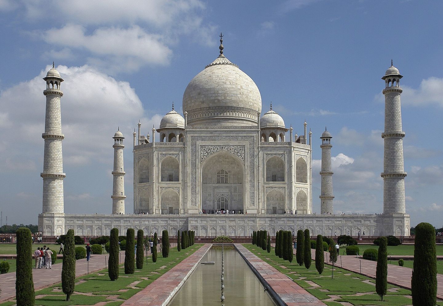 The Taj Mahal at sunrise, reflected in a pool